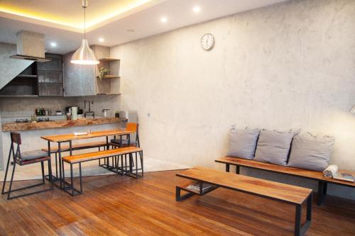 a kitchen with wooden tables and chairs and a counter at Flores Passport House in Ende