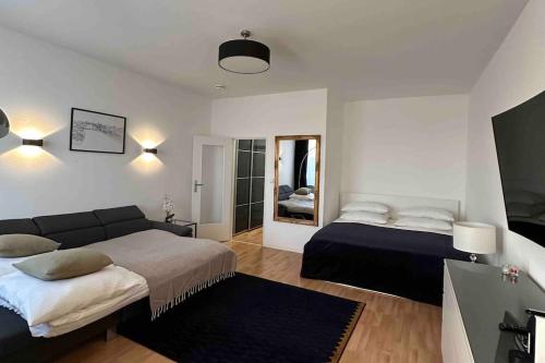 a living room with two beds and a couch at City Apartment am Ku'damm & ICC Messe/Free Parking in Berlin