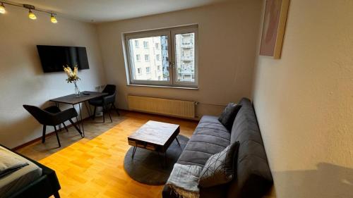 a living room with a couch and a table at Apartment 2 im Lehenviertel in Stuttgart