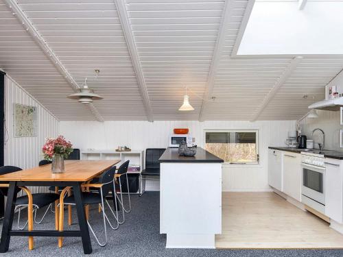 a kitchen and dining room with a table and chairs at 6 person holiday home in Ansager-By Traum in Ansager