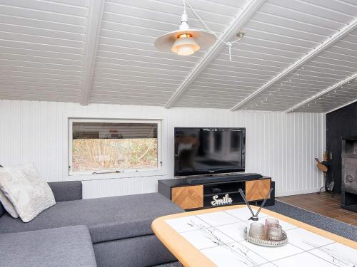 a living room with a couch and a flat screen tv at 6 person holiday home in Ansager-By Traum in Ansager