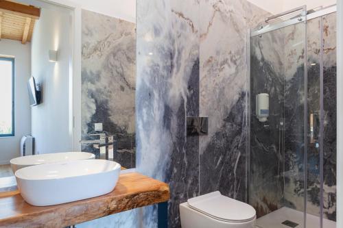 a bathroom with a sink and a shower at Hotel Quinta da Tulha By VimaHotels in Guimarães