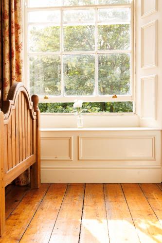 an empty room with a window and a wooden floor at Preston House in Abbeyleix