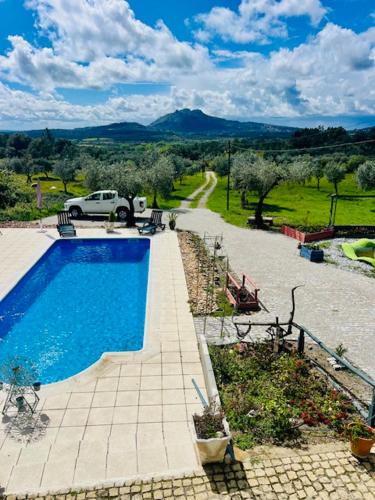 a car is parked next to a swimming pool at Zion Jardim Monsanto in Monsanto