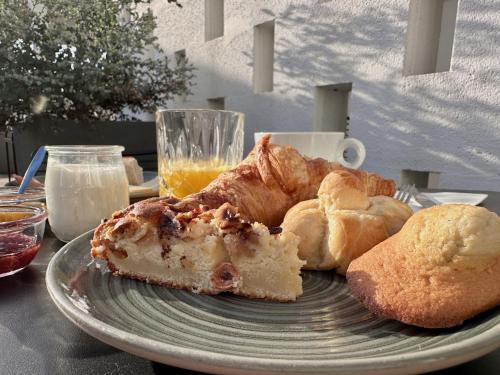 a plate with a piece of pie and bread on a table at Logis Hôtel & Restaurant Le Vert Bocage in Franqueville-Saint-Pierre