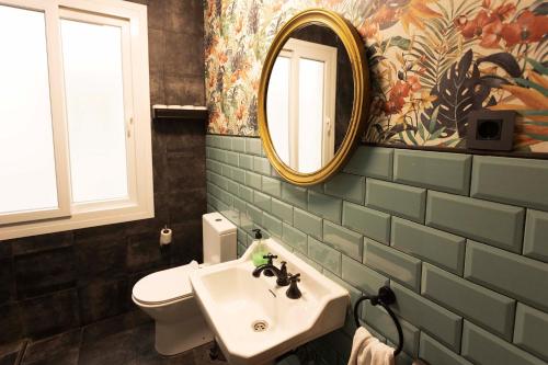 a bathroom with a sink and a mirror at Green Hostel Oviedo in Oviedo