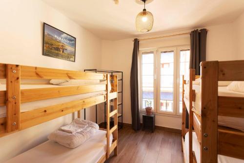 a room with three bunk beds and a window at Green Hostel Oviedo in Oviedo