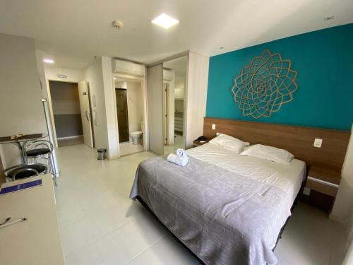 a bedroom with a large bed with a blue wall at FUSION in Brasilia