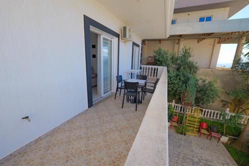 a balcony of a house with a table and chairs at Villa Xika in Sarandë
