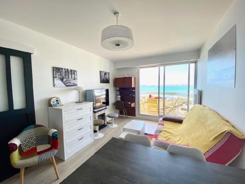 - une chambre avec un lit et un bureau offrant une vue sur l'océan dans l'établissement Brise Marine, à Saint-Gilles-Croix-de-Vie