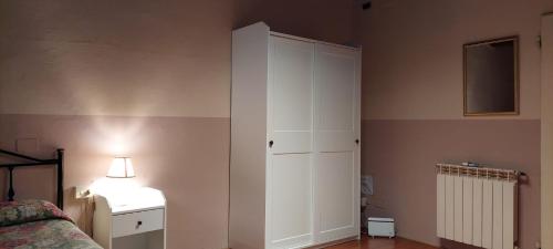 a bedroom with a bed and a white cabinet at Hotel Medici in Florence