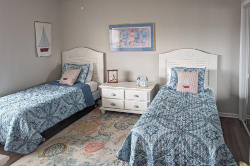 a bedroom with two beds and a night stand at Bethany Bay Condos in Ocean View