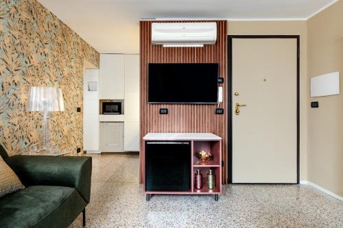 a living room with a couch and a flat screen tv at Venice Suite San Marco 213 in Venice