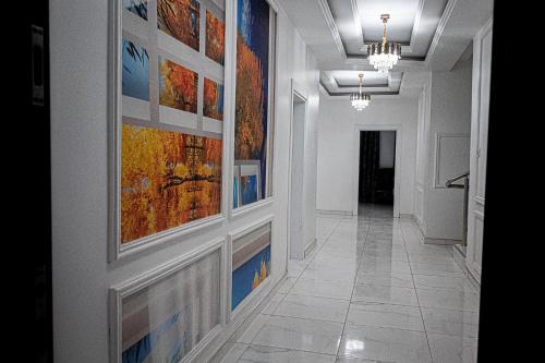 a hallway with paintings on the walls of a building at VEGAS APERTMENT in Amdalai
