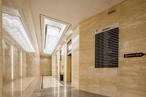 a hallway of a building with a sign on the wall at Orange Apartments in Chengdu