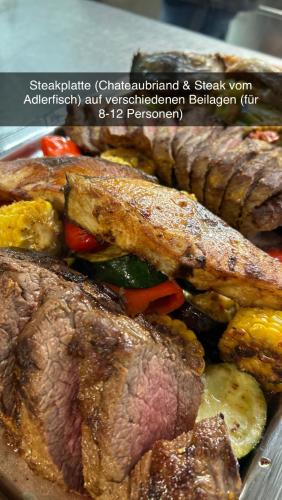 a plate of food with meat and vegetables at Hotel-Restaurant Gasthaus Bonimeier in Niedergottsau