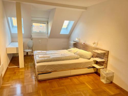 a bedroom with a bed in a room with skylights at Quiet Attic-Apartment Bern Center in Bern
