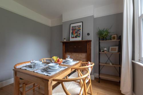 a dining room table with a bowl of fruit on it at 2 Bed Apartment in Sydenham, London in Forest Hill