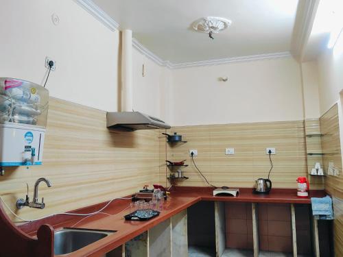 a kitchen with a wooden counter and a sink at Shree Niwas Home Stay in Varanasi