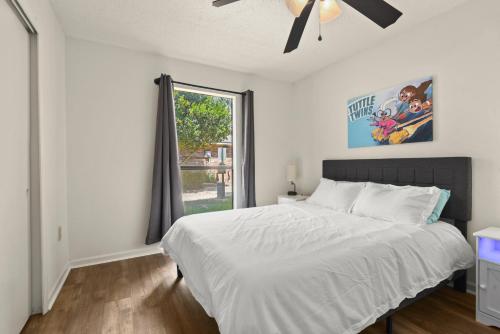 a bedroom with a large bed and a window at LSU 2Bed/2Bath Angel Studios Condo *NEW* in Baton Rouge