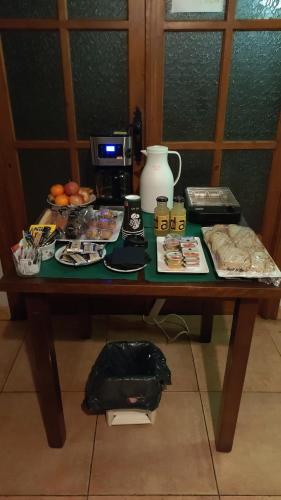 a table with a coffee maker and food on it at Pension Parrilla Casa Vicente in Tineo