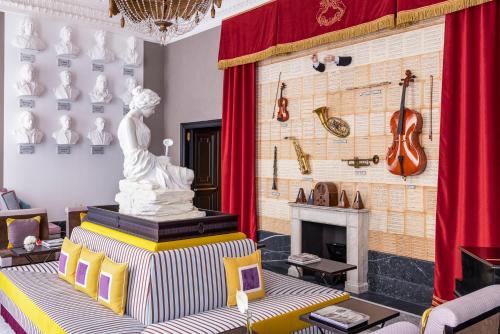 a living room with a statue and a fireplace at Palazzo Roma - The Leading Hotels of the World in Rome