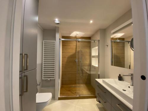 a bathroom with a shower and a toilet and a sink at ~ Luxury Downtown Haven in Wrocław
