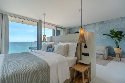 a bedroom with a bed with a view of the ocean at Blu Mare Hotel in Novigrad Istria