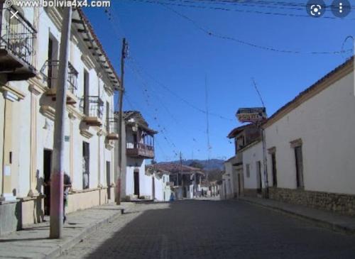 an empty street in a town with white buildings at Cabaña Villa San Lorenzo in Tomatas