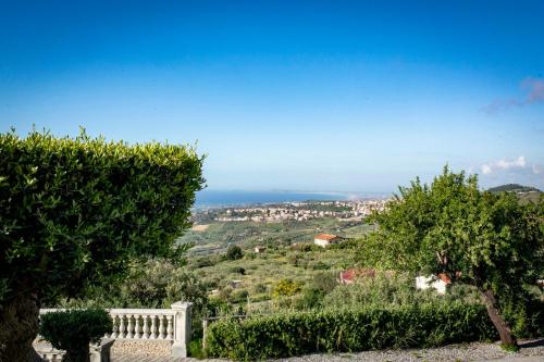 a view of a city from a hill with trees at Tenuta Pietravera in Furnari