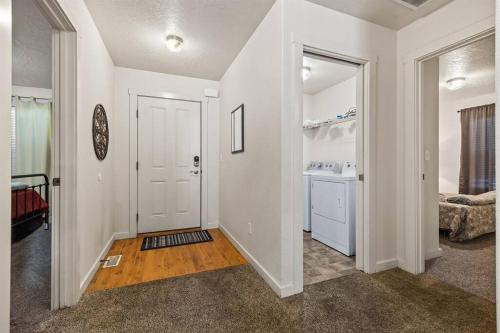 a hallway with a white door and a bathroom at Charming Private Twnhome w/ Large Fenced Yard (58) in Meridian