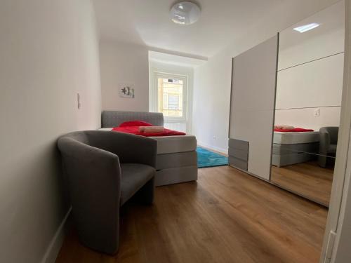 a bedroom with a bed and a mirror at Schöner Wohnen in Stuttgart Ost in Stuttgart