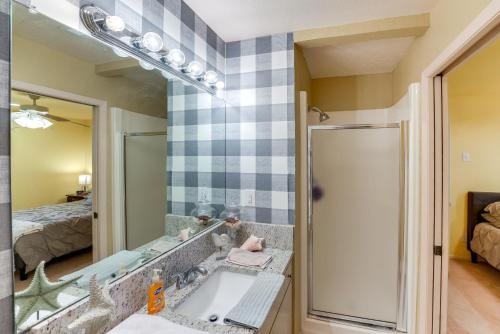 a bathroom with a sink and a mirror at Boat Slip Access North Padre Island Condo! in Padre Island