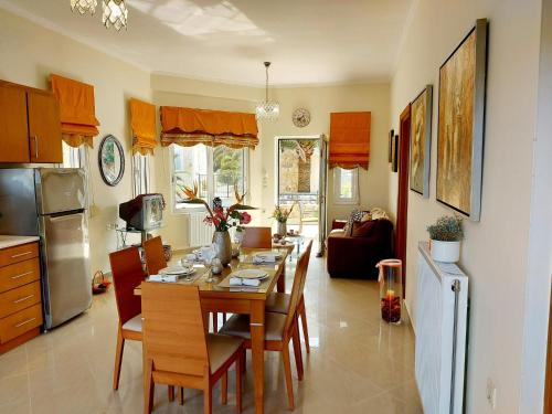 a kitchen and dining room with a table and chairs at Socrates Holidays Apartment in Kamisianá