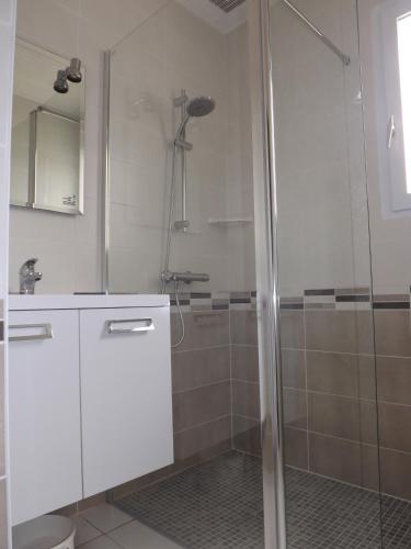 une salle de bain avec une douche avec une porte vitrée dans l'établissement Le Boisvinet, à Saint-Gilles-Croix-de-Vie