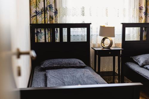 a bedroom with a bed and a lamp and a window at Leon's home in Şelimbăr