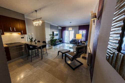 a kitchen and living room with a table and chairs at Apartamentos Abril in Nerja