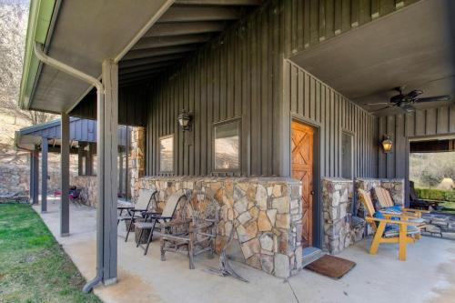 a house with a stone fireplace on the side of it at Bluff View Farm in West Jefferson