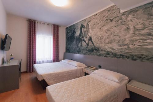 Uma cama ou camas num quarto em Hotel Gattopardo