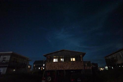a small building with lights on in the dark at SEA ESCAPE cottage in Buxton