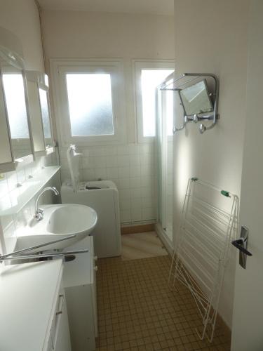 une salle de bain blanche avec un lavabo et une douche dans l'établissement La Sauvageonne, à Saint-Gilles-Croix-de-Vie