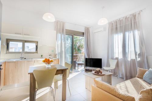 a kitchen and living room with a table and a couch at Iriana's Apartments in Center in Chania