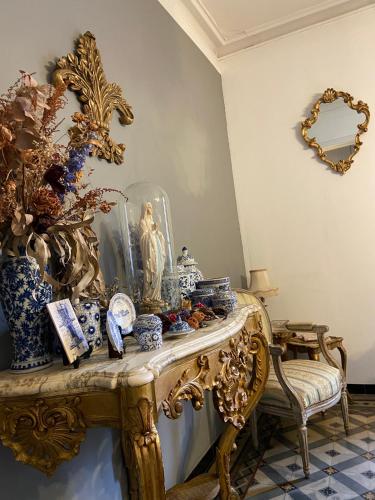 a table topped with blue and white vases and a mirror at Maison 1823 - Suites de charme à Garons in Garons