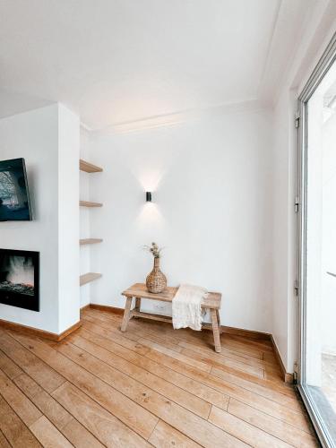 a living room with a bench and a fireplace at Appartement Montfleuri in Ostend
