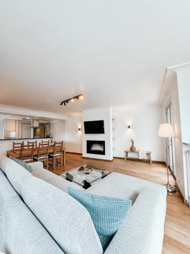 a living room with two couches and a table at Appartement Montfleuri in Ostend