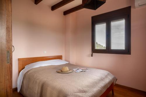 a bedroom with a bed with a hat on it at Verano Family House in Voútai