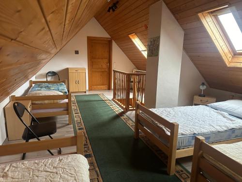 a room with three beds in a attic at Ferienwohnung Gut-Wattberg in Hofgeismar