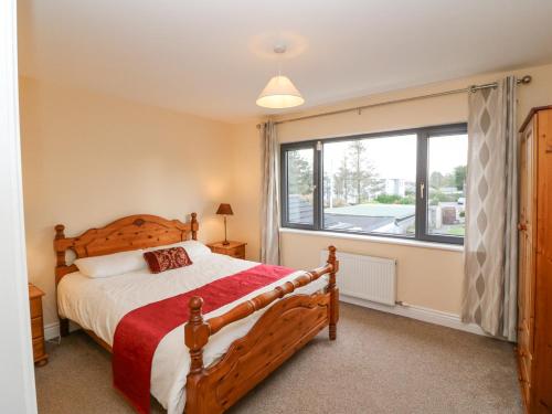a bedroom with a bed and a large window at 3 Railway Terrace in Killorglin
