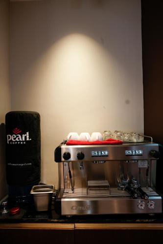 a coffee maker sitting on top of a counter at Lakhey Hotel in Kathmandu