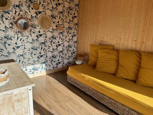 a bed in a room with a wall at L'atelier de la clef des Paons in Luc-sur-Mer